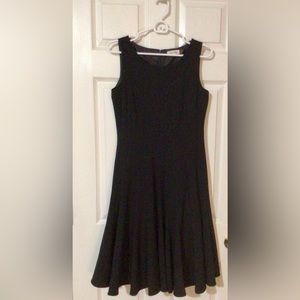 A black, pleated dress by Calvin Klein, size 6, barely worn.